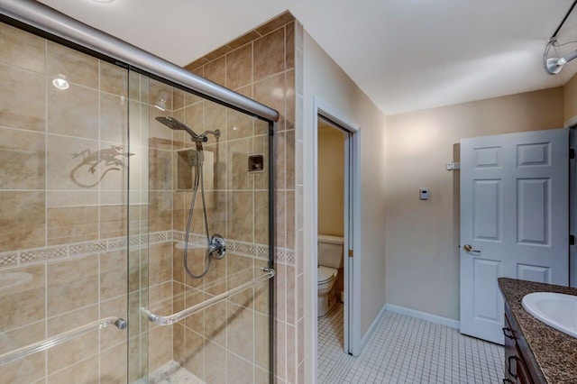 full bathroom with tile patterned floors, toilet, a stall shower, and vanity