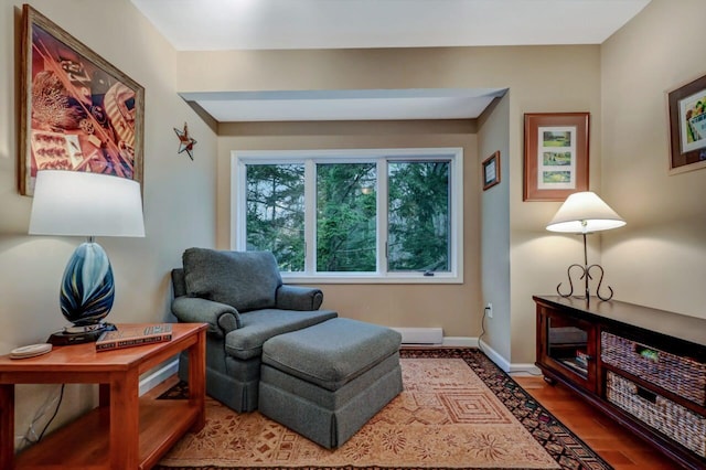 living area with wood finished floors and baseboards