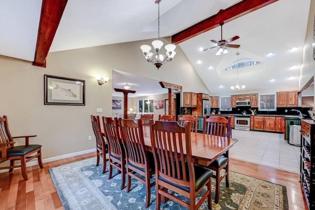 dining room with beamed ceiling, light wood-style flooring, high vaulted ceiling, and ceiling fan with notable chandelier