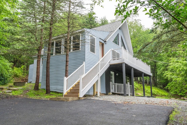 115 Tumbleweed Dr, Long Pond, PA 18334 - view of front of property featuring stairway, a shingled roof, and a deck
