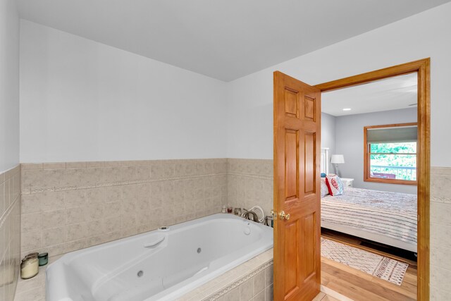 5194 S Hamilton S, Saylorsburg, PA 18353 - ensuite bathroom featuring a jetted tub, wainscoting, and tile walls