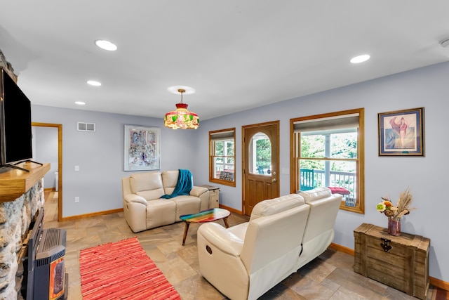 5194 S Hamilton S, Saylorsburg, PA 18353 - living room featuring stone tile floors, recessed lighting, and a wood stove
