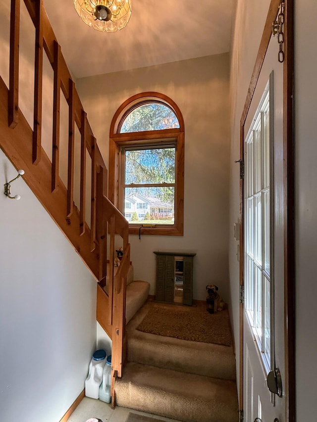 foyer entrance featuring baseboards and stairs