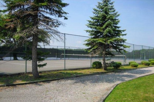 view of tennis court featuring fence