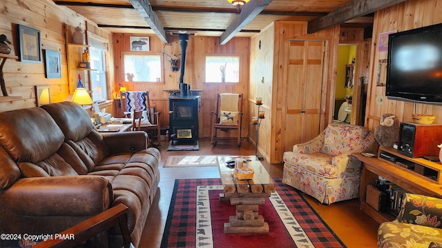 2124 Meadowlark Cir, Bushkill, PA 18324 - living room featuring wood walls, a wood stove, wood finished floors, beam ceiling, and wood ceiling