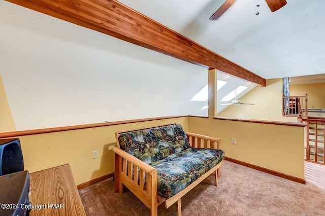 sitting room with vaulted ceiling with beams, carpet, baseboards, and ceiling fan