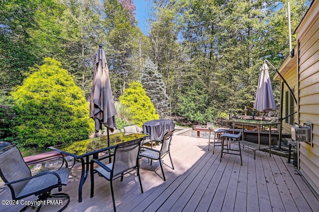 wooden terrace with outdoor dining space