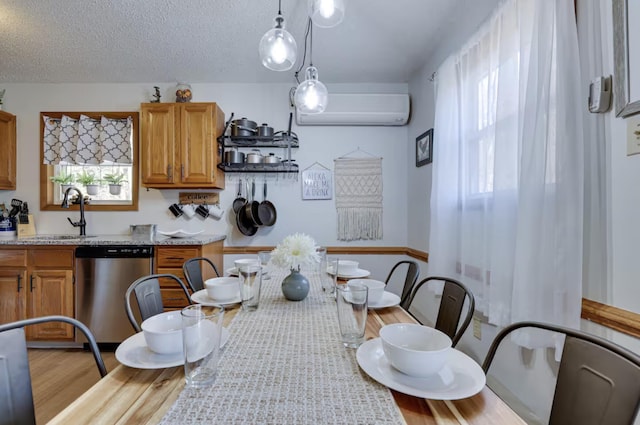 dining room featuring a wall mounted air conditioner, a textured ceiling, and wood finished floors