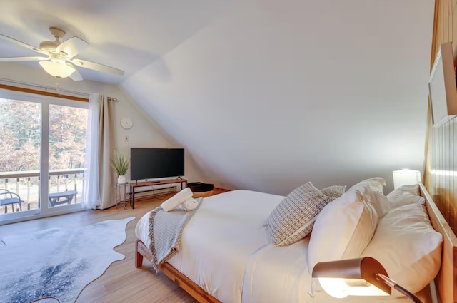 bedroom featuring ceiling fan, vaulted ceiling, access to exterior, and wood finished floors