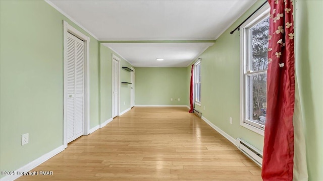 115 Aspen Cir E, Stroudsburg, PA 18302 - corridor featuring a baseboard radiator, crown molding, and light wood-style flooring