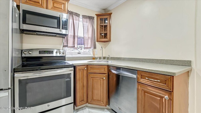 115 Aspen Cir E, Stroudsburg, PA 18302 - kitchen with appliances with stainless steel finishes, ornamental molding, and brown cabinets