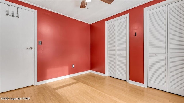 115 Aspen Cir E, Stroudsburg, PA 18302 - unfurnished bedroom featuring light wood-style flooring, multiple closets, ornamental molding, and ceiling fan