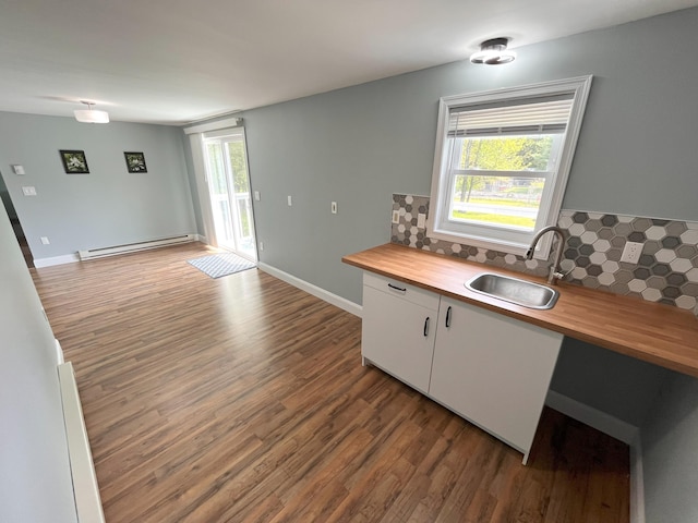 20 Occoquan Trl, Albrightsville, PA 18210 - kitchen with butcher block counters, a sink, a baseboard heating unit, wood finished floors, and decorative backsplash