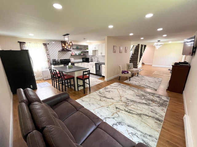 20 Occoquan Trl, Albrightsville, PA 18210 - living room with a baseboard heating unit, stairs, recessed lighting, baseboards, and light wood finished floors