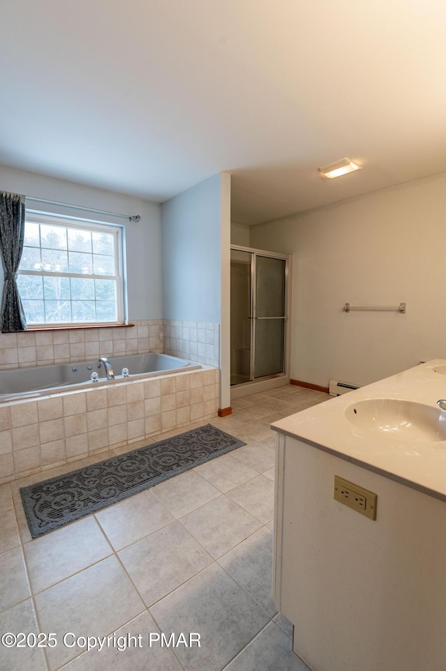 bathroom with a baseboard radiator, a sink, tile patterned flooring, a shower stall, and a garden tub