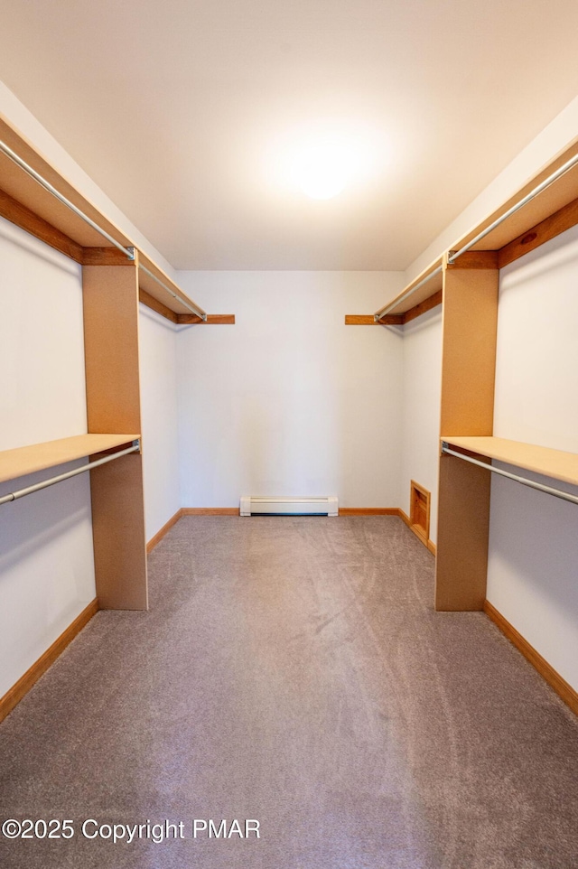 walk in closet featuring baseboard heating and carpet floors