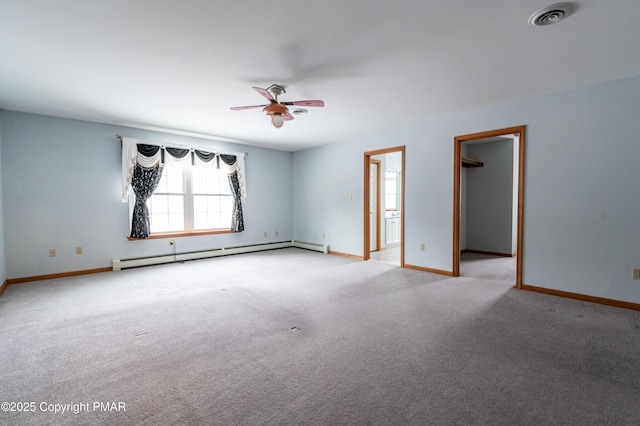 spare room featuring visible vents, light carpet, a baseboard radiator, baseboards, and ceiling fan