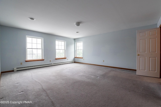 carpeted spare room featuring baseboards, visible vents, and baseboard heating