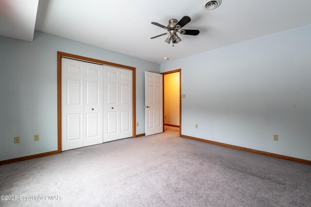 unfurnished bedroom featuring a closet, visible vents, carpet flooring, and baseboards