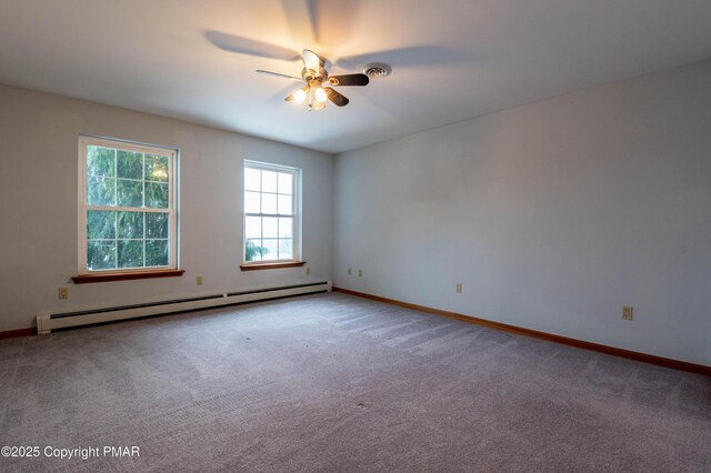 carpeted spare room featuring a baseboard heating unit, a ceiling fan, and baseboards