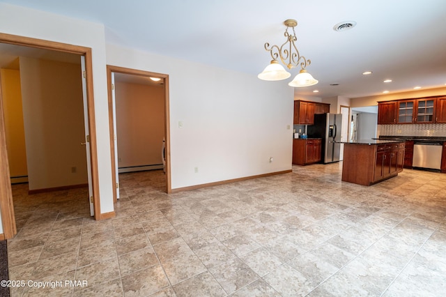 kitchen featuring baseboards, visible vents, appliances with stainless steel finishes, dark countertops, and a center island