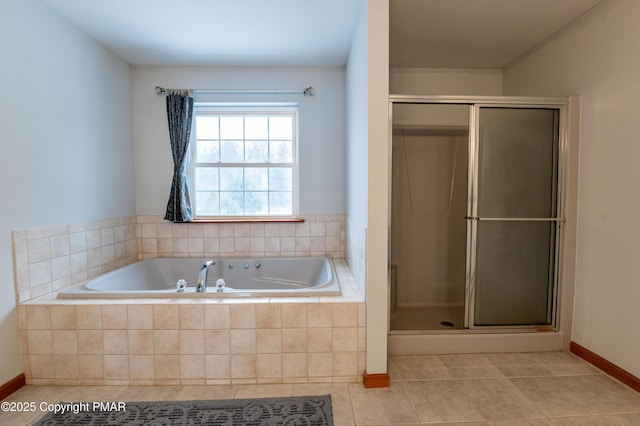 full bath featuring tile patterned floors, baseboards, a stall shower, and a bath