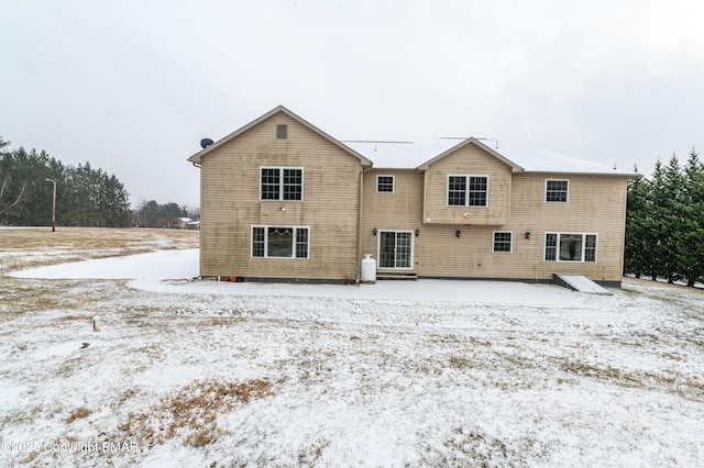 view of snow covered rear of property