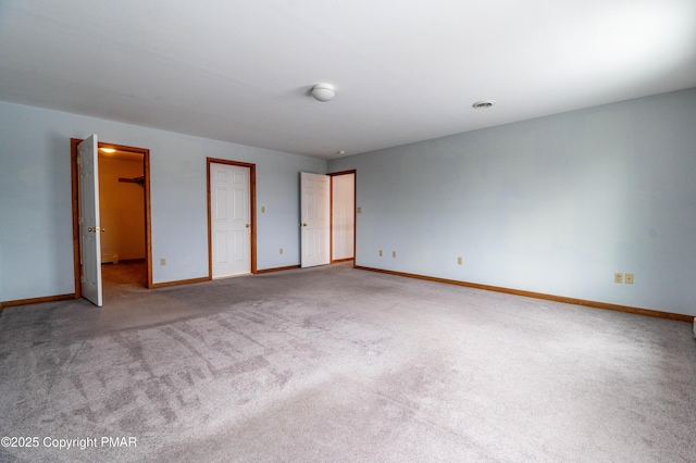 unfurnished bedroom featuring visible vents, baseboards, and carpet floors