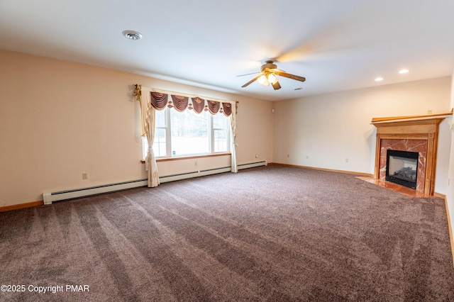 unfurnished living room with carpet, a ceiling fan, baseboards, a baseboard radiator, and a high end fireplace