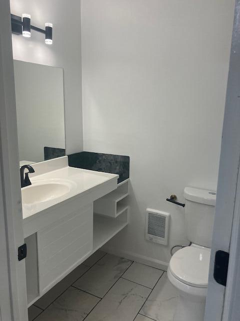 3354 Trafalgar Ave, East Stroudsburg, PA 18302 - half bath with marble look tiles, vanity, and heating unit