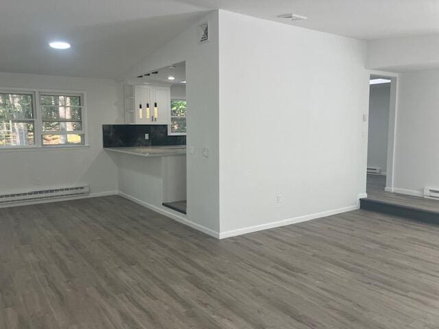 3354 Trafalgar Ave, East Stroudsburg, PA 18302 - unfurnished living room with a baseboard heating unit, dark wood-type flooring, plenty of natural light, recessed lighting, and lofted ceiling