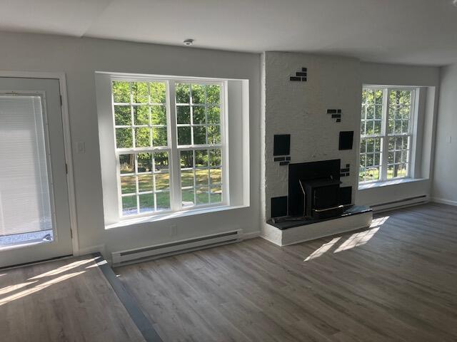 3354 Trafalgar Ave, East Stroudsburg, PA 18302 - unfurnished living room with a baseboard heating unit, plenty of natural light, and wood finished floors