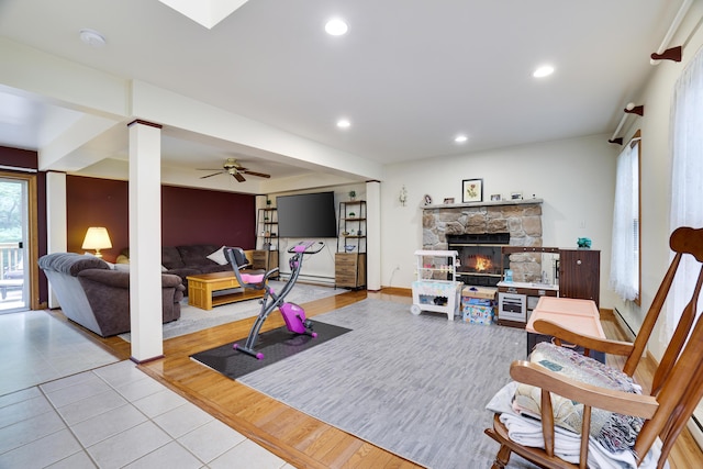 5286 Hilltop Cir E, Stroudsburg, PA 18301 - living room with light tile patterned floors, a fireplace, recessed lighting, a ceiling fan, and baseboard heating