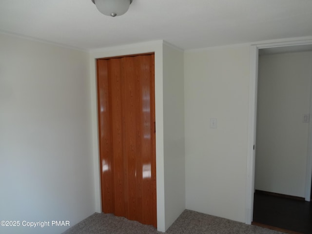 unfurnished bedroom with a closet and carpet flooring