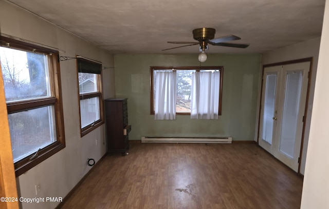 interior space with ceiling fan, baseboard heating, and wood finished floors