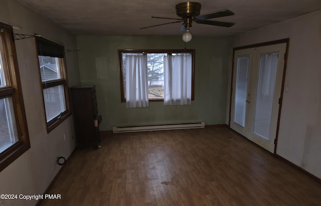 unfurnished bedroom with a ceiling fan, a baseboard heating unit, wood finished floors, and french doors