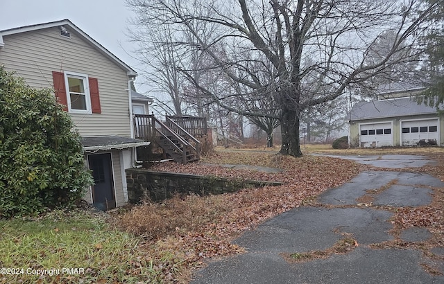 view of yard with stairs and a detached garage