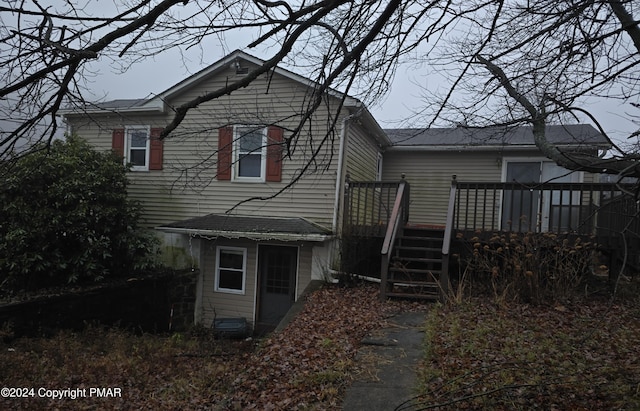 back of property with stairway and a wooden deck