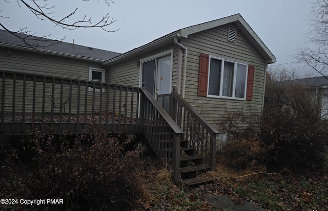 view of side of home with a deck