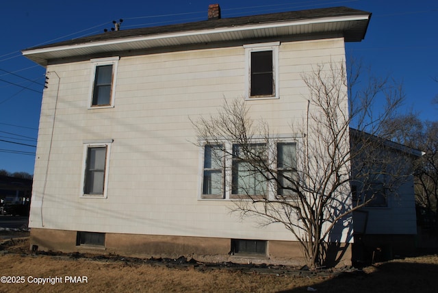 view of property exterior with a chimney