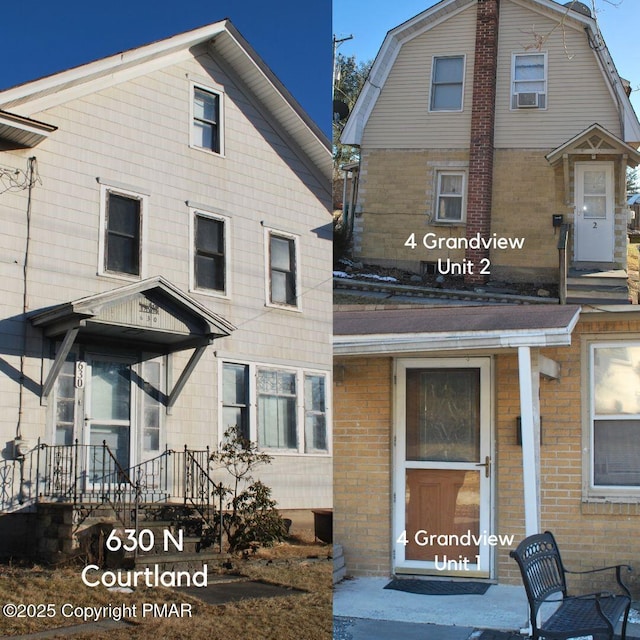 exterior space featuring brick siding, a gambrel roof, and cooling unit