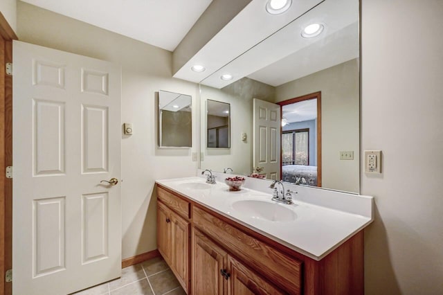 full bath with a sink, tile patterned floors, recessed lighting, and double vanity