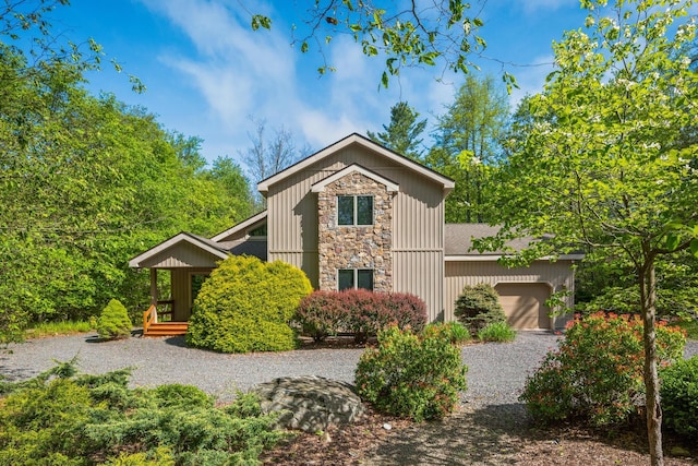600 Conestoga Trl, Pocono Pines, PA 18350 - mid-century home featuring stone siding, an attached garage, and driveway