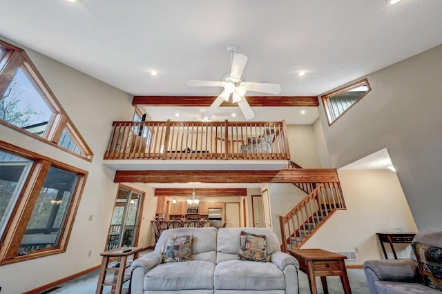 carpeted living area featuring stairway, baseboards, a high ceiling, and recessed lighting