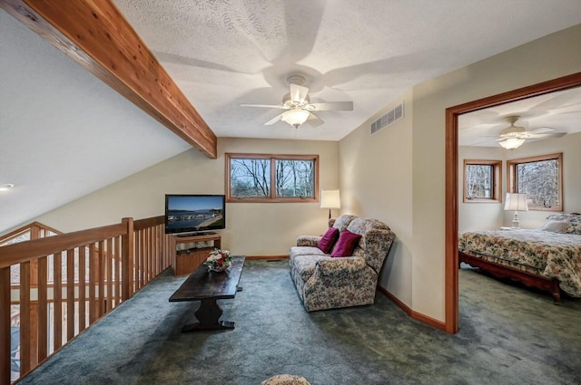 carpeted living area with baseboards, ceiling fan, visible vents, and a wealth of natural light