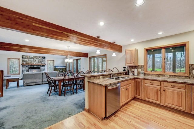 kitchen featuring a sink, recessed lighting, a peninsula, a wealth of natural light, and stainless steel dishwasher