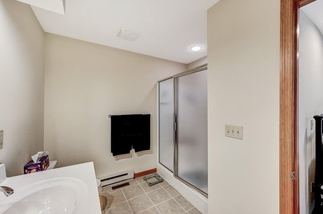 bathroom with tile patterned floors, a sink, baseboard heating, and a stall shower