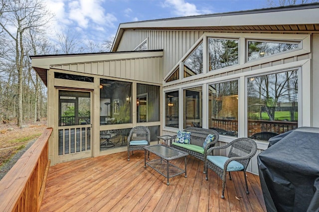 deck featuring a sunroom and an outdoor hangout area