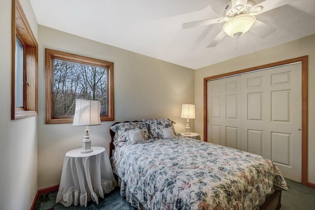 carpeted bedroom featuring baseboards, a ceiling fan, and a closet