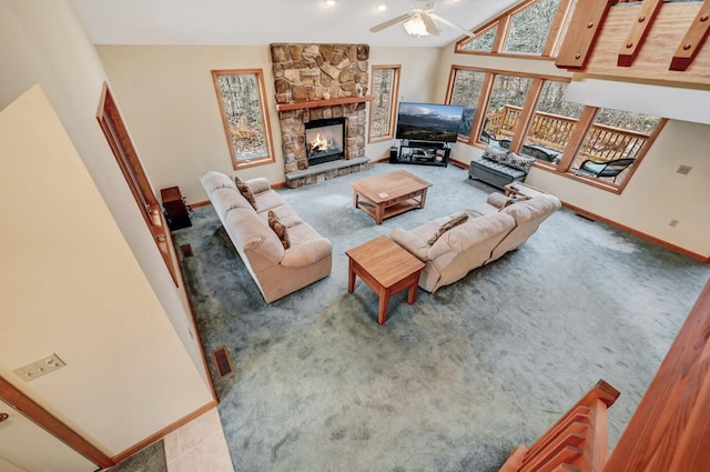 living room with baseboards, a ceiling fan, carpet, and a fireplace